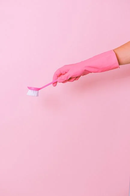 Cleaner using a vacuum in a stylish indoor setting, showcasing cleaning equipment and techniques.
